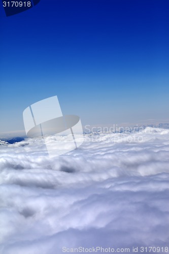 Image of Mountains under clouds in sun winter day