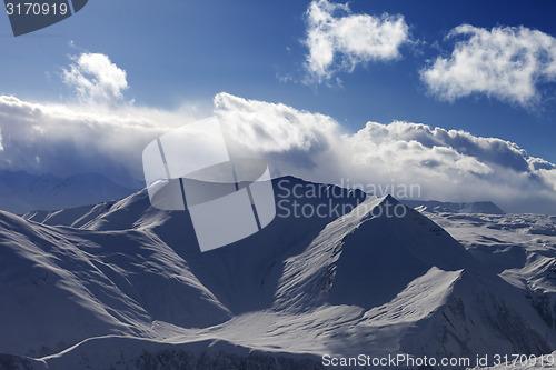 Image of Snow mountains and sunlight clouds in evening