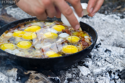 Image of Fried eggs. Cooking on the campfire.