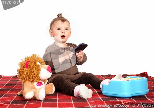 Image of Baby playing with cell phone.