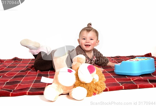 Image of Smiling girl lying on floor.