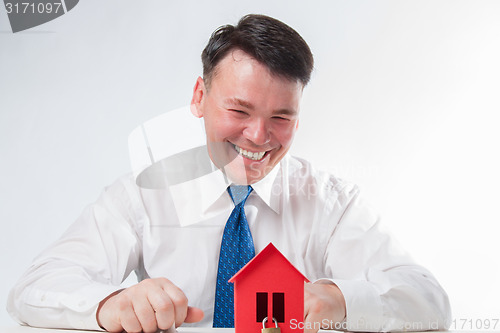 Image of Man with a red paper house