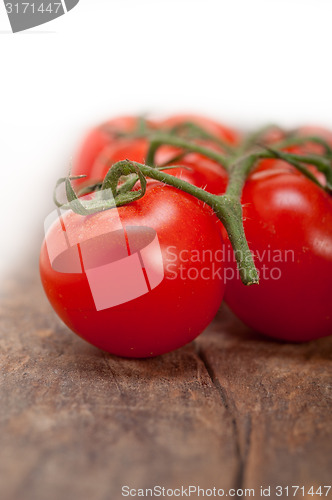 Image of fresh cherry tomatoes on a cluster