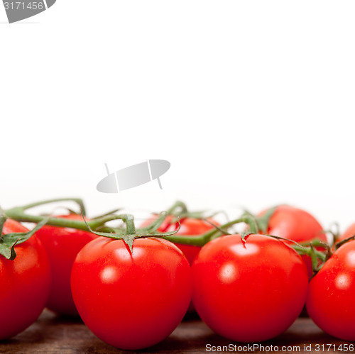 Image of fresh cherry tomatoes on a cluster