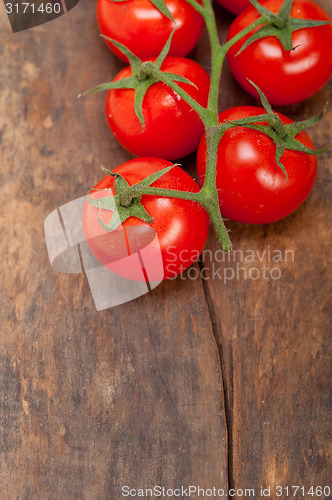 Image of fresh cherry tomatoes on a cluster