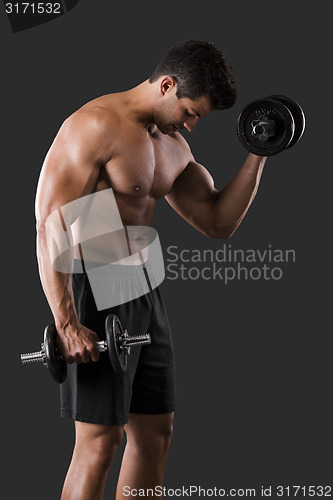 Image of Muscular man lifting weights