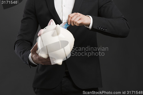 Image of Holding a piggy bank