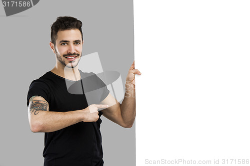 Image of Latin man holding a blank billboard