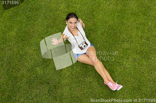 Image of Beautiful girl lying on the grass