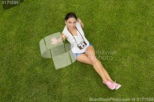 Image of Beautiful girl lying on the grass