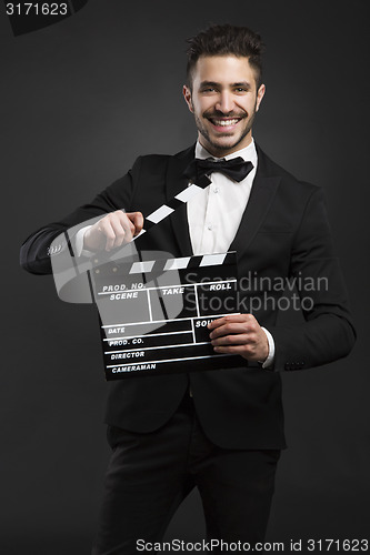 Image of Man holding a clapboard