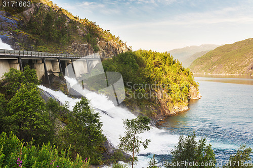 Image of Road in Norway passing over the waterfall Langfoss