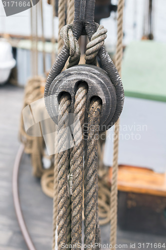 Image of Wooden sailboat pulleys and ropes detail