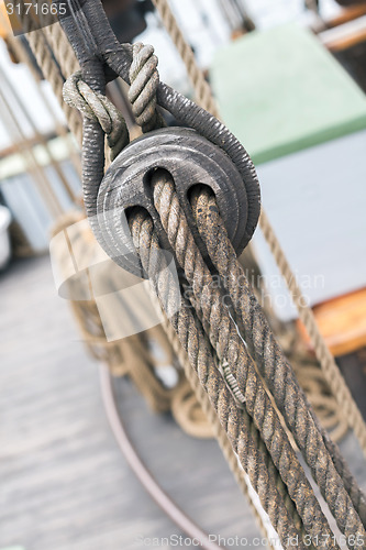 Image of Wooden sailboat pulleys and ropes detail