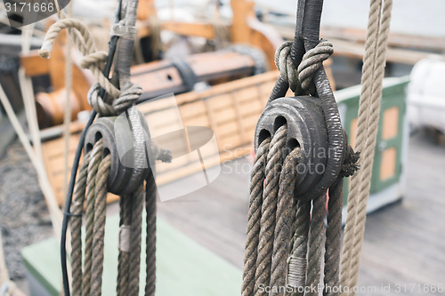 Image of Wooden sailboat pulleys and ropes detail