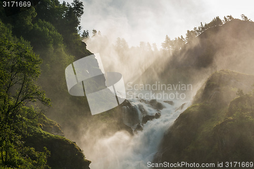 Image of Mountain creek cascade with fresh green moss on the stones, long exposure for soft water look