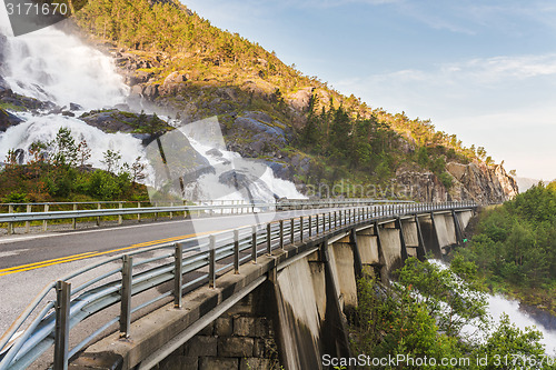 Image of Road in Norway passing over the waterfall Langfoss