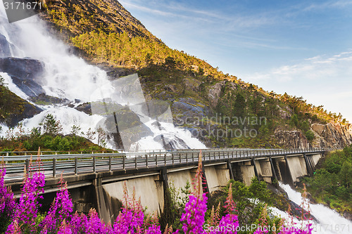 Image of Road in Norway passing over the waterfall Langfoss