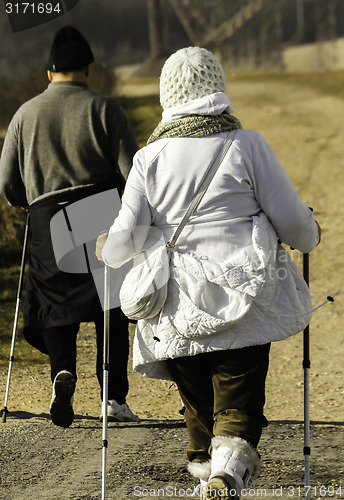 Image of Senior couple walking down the path