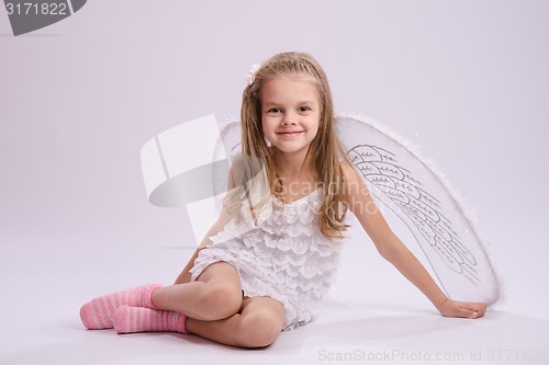 Image of Sitting girl in angel costume