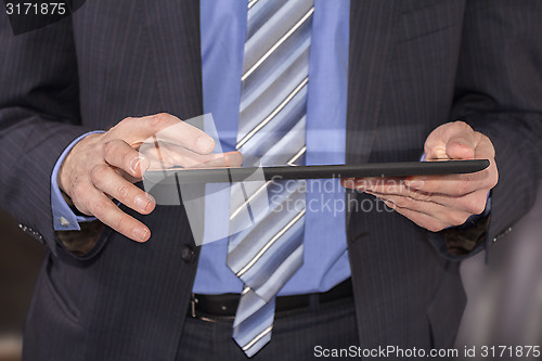 Image of Business man using tablet