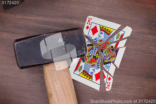 Image of Hammer with a broken card, king of diamonds