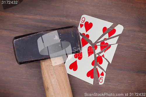 Image of Hammer with a broken card, nine of hearts