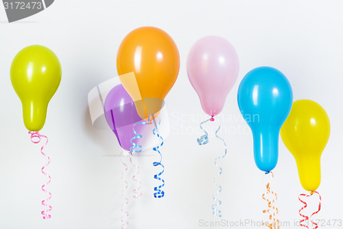 Image of Balloons of different bright colors on a white background