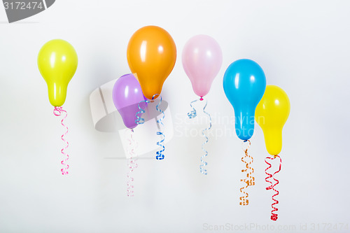 Image of Balloons of different bright colors on a white background