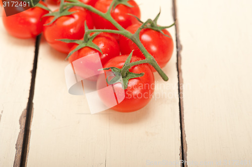 Image of fresh cherry tomatoes on a cluster