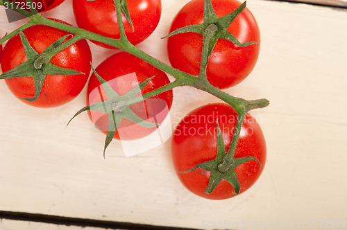 Image of fresh cherry tomatoes on a cluster