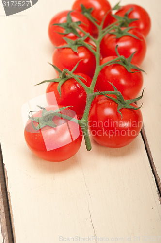 Image of fresh cherry tomatoes on a cluster
