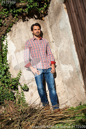 Image of Male model sitting with legs crossed