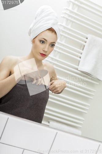 Image of Woman From Shower Looking her Face at the Mirror