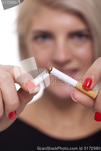 Image of Close up Young Woman Breaking a Cigarette Stick