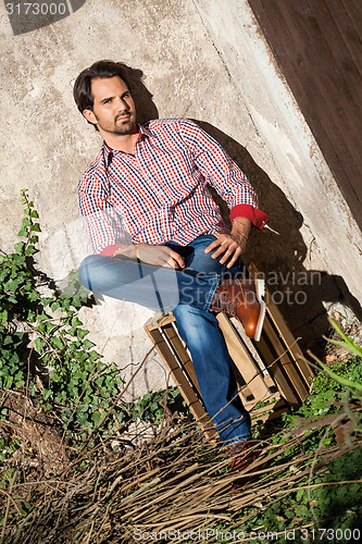 Image of Male model sitting with legs crossed