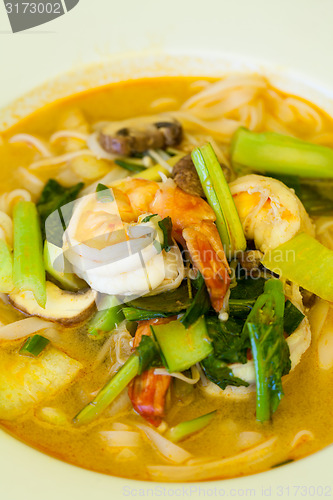 Image of Bowl of traditional Thai tom yam soup