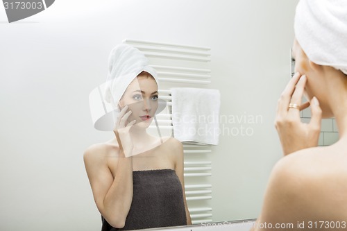 Image of Woman From Shower Looking her Face at the Mirror