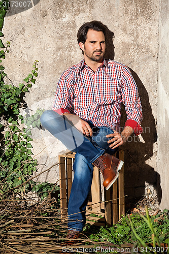 Image of Male model sitting with legs crossed