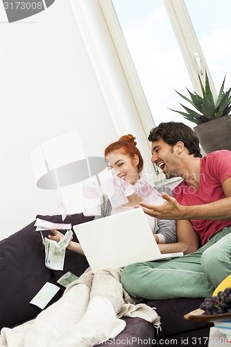 Image of Sitting Happy Couple Throwing Money in the Air