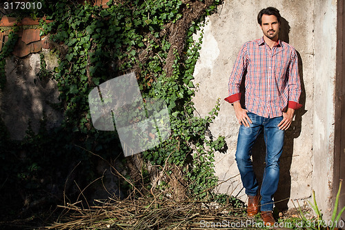 Image of Male model sitting with legs crossed