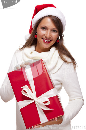 Image of Pretty woman in a Santa hat with a large gift