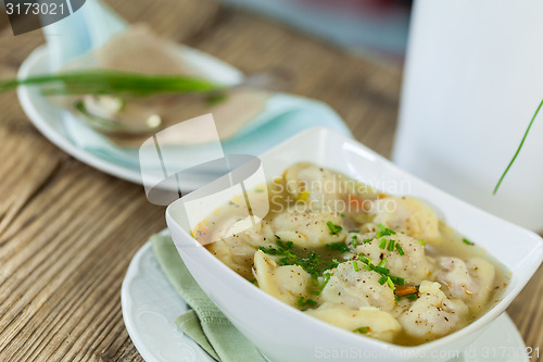 Image of Dish of savory pork tortellini in broth pelmeni russian