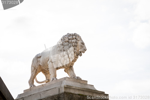 Image of Bird perched on an ancient stone statue