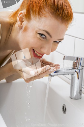 Image of Woman Washing her Face While Looking at the Camera