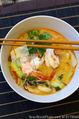 Image of Bowl of traditional Thai tom yam soup