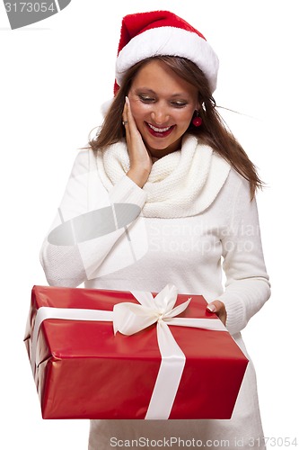 Image of Pretty woman in a Santa hat with a large gift