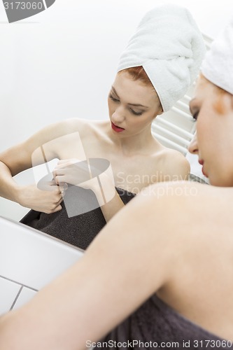 Image of Woman From Shower Looking her Face at the Mirror