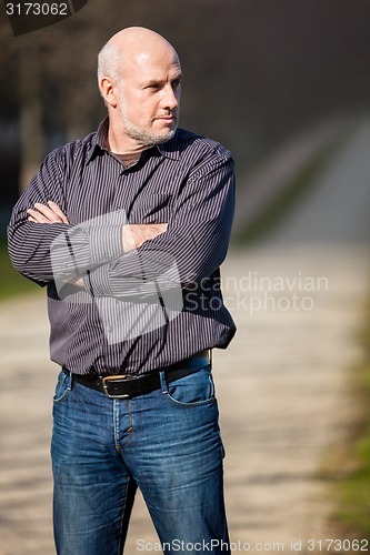 Image of Confident attractive man standing waiting