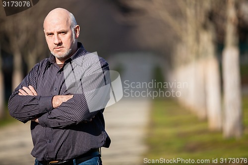 Image of Confident attractive man standing waiting